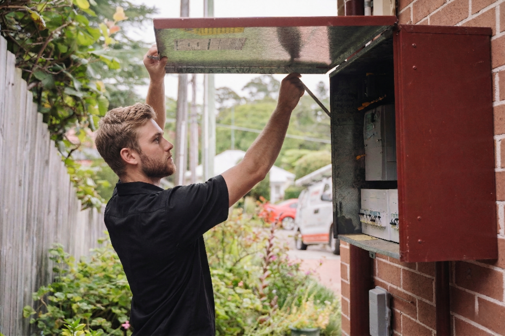 Electrician installing downlights in a Darlinghurst home
